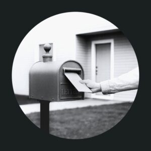 Hand placing mail into a mail box.