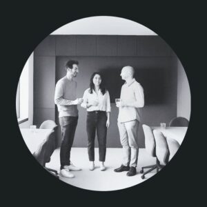 Three people socialising in an office.