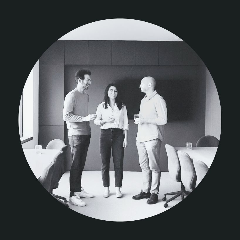 Three people socialising in an office.